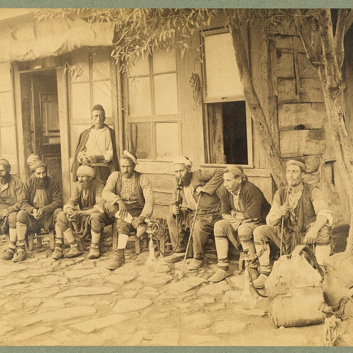 Men seated outside a coffee house in Istanbul, photographed by Sébah and Joaillier, 1890s